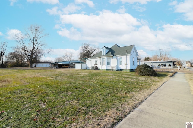 view of home's exterior featuring a yard and a carport