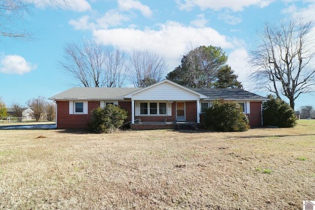 single story home with covered porch and a front yard