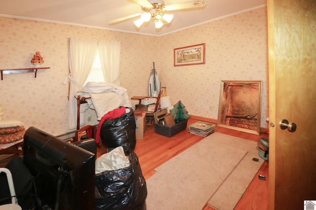 interior space featuring hardwood / wood-style flooring, ceiling fan, and ornamental molding