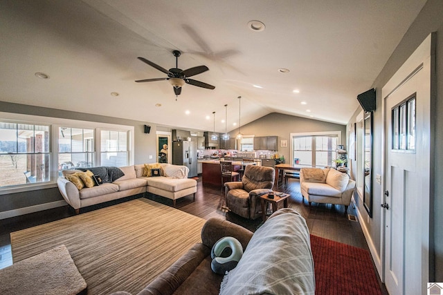 living room featuring vaulted ceiling, ceiling fan, and dark hardwood / wood-style floors