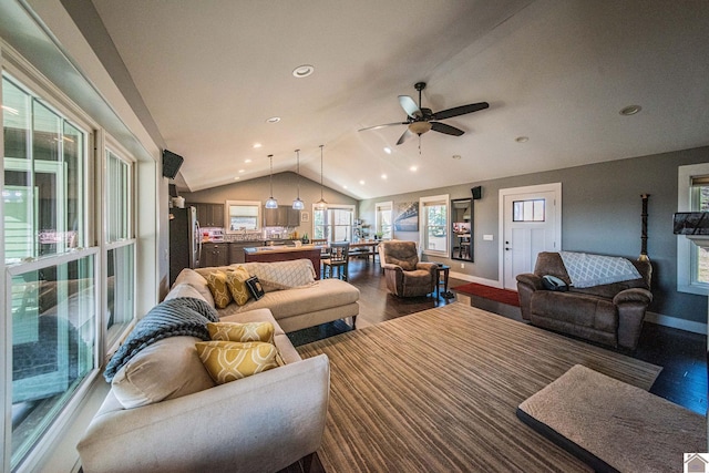 living room featuring ceiling fan, hardwood / wood-style floors, and lofted ceiling