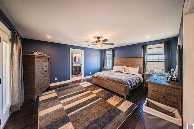 bedroom featuring ceiling fan, connected bathroom, and dark hardwood / wood-style flooring