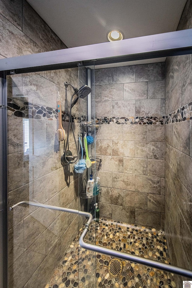 interior space featuring a shower with door