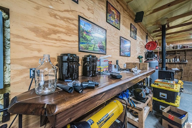 bar with a wood stove, wooden counters, and wooden walls