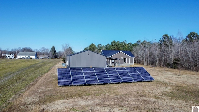 rear view of house featuring solar panels