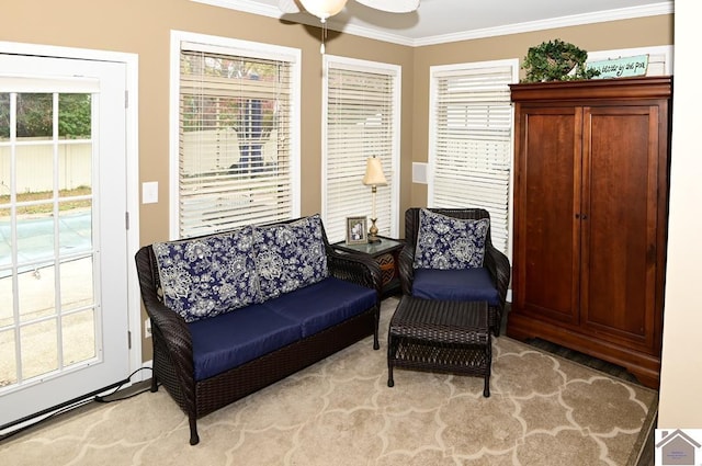 sitting room with crown molding and a wealth of natural light