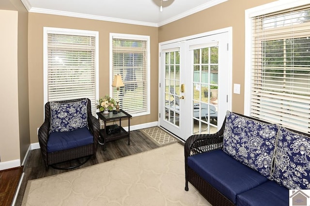 sitting room with crown molding, hardwood / wood-style floors, and french doors