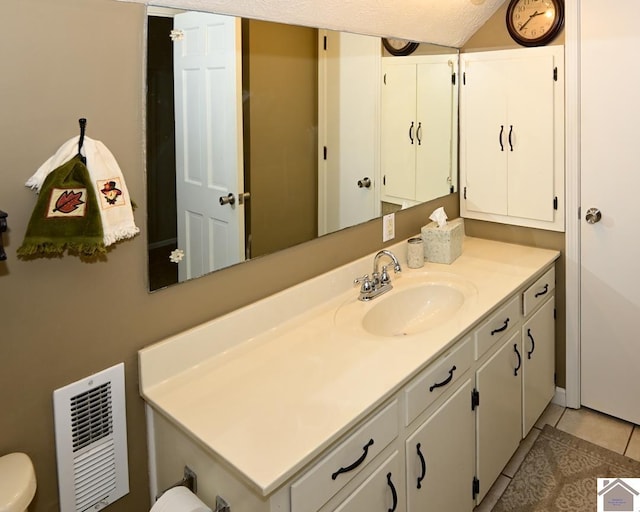 bathroom with tile patterned floors and vanity