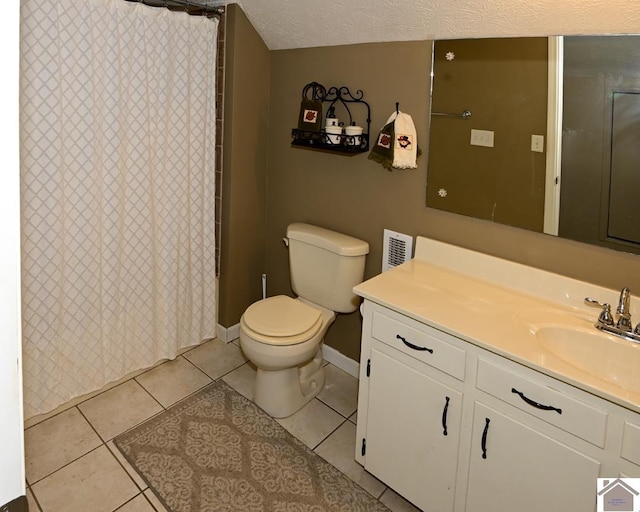 bathroom featuring toilet, a textured ceiling, tile patterned floors, and vanity