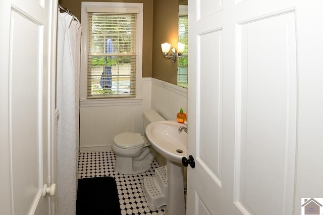 bathroom featuring toilet and tile patterned flooring