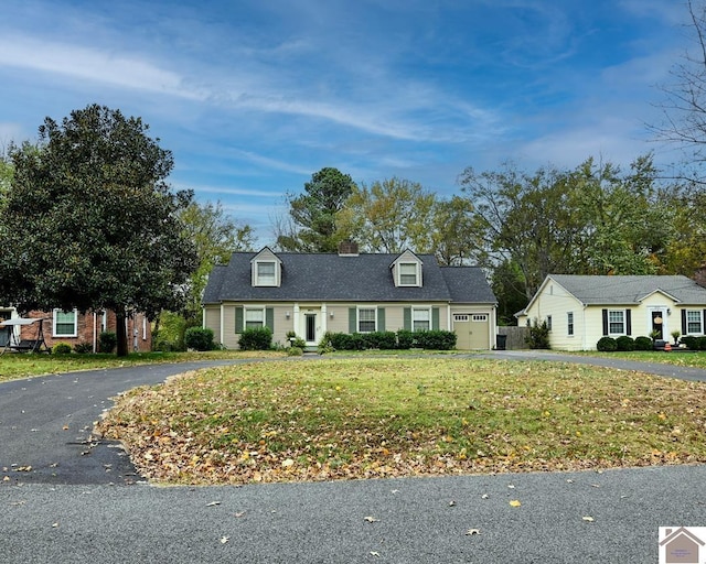 view of front of property featuring a garage and a front yard