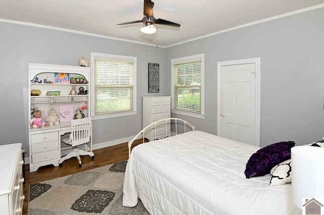 bedroom featuring crown molding, dark wood-type flooring, and ceiling fan