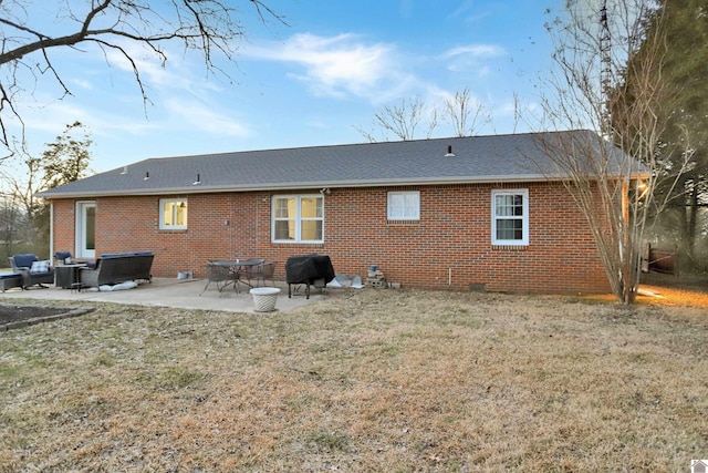 back of property with a patio area and a yard