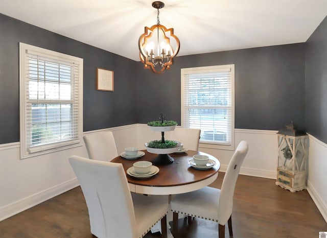 dining area featuring a chandelier and dark hardwood / wood-style flooring