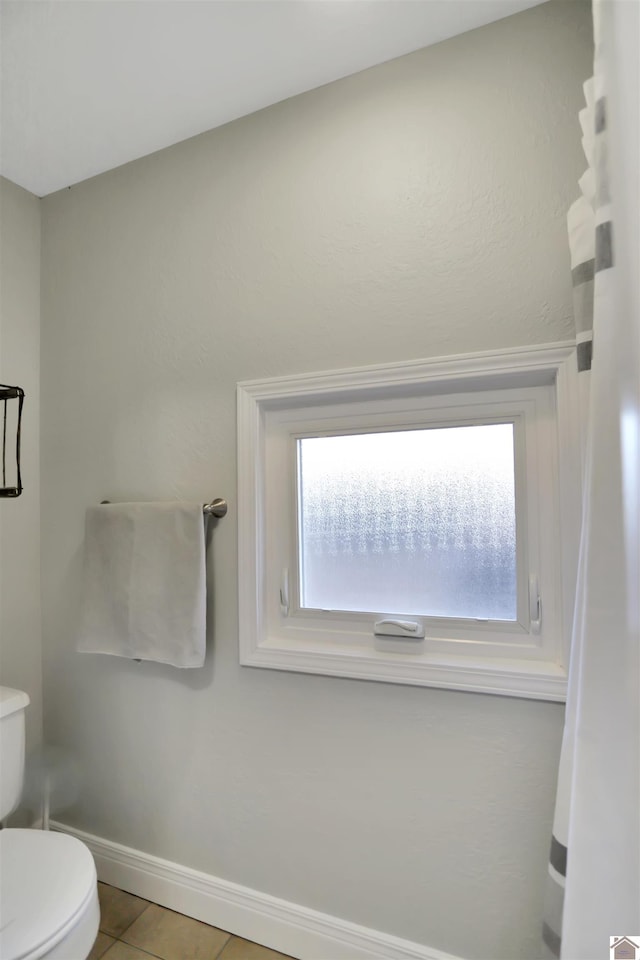 bathroom featuring toilet and tile patterned flooring