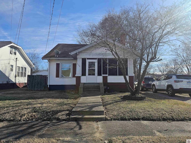 bungalow-style home featuring a front lawn