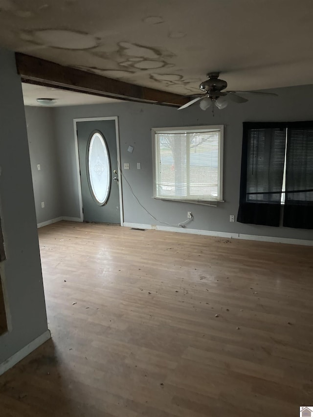 entryway featuring ceiling fan, light hardwood / wood-style flooring, and beam ceiling