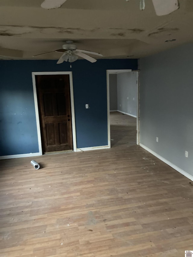 spare room with light wood-type flooring and ceiling fan