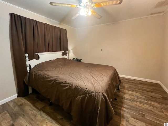 bedroom featuring ceiling fan, crown molding, and dark wood-type flooring