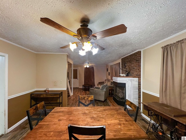 dining room featuring hardwood / wood-style flooring, crown molding, and a textured ceiling