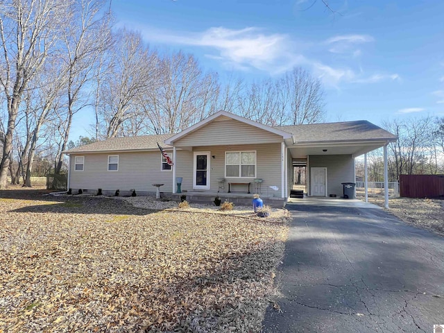 ranch-style home with covered porch and a carport