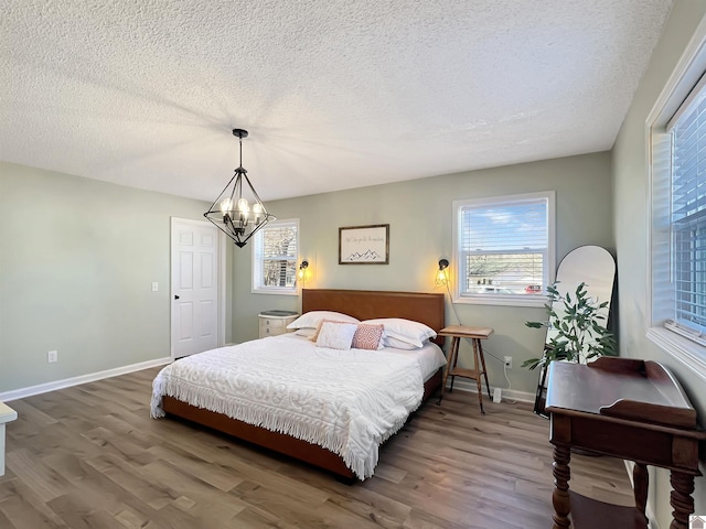 bedroom with hardwood / wood-style flooring and a textured ceiling