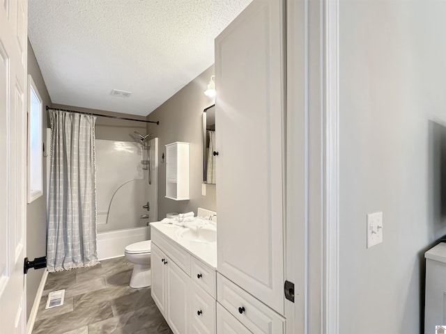 full bathroom with vanity, toilet, shower / bath combo, and a textured ceiling