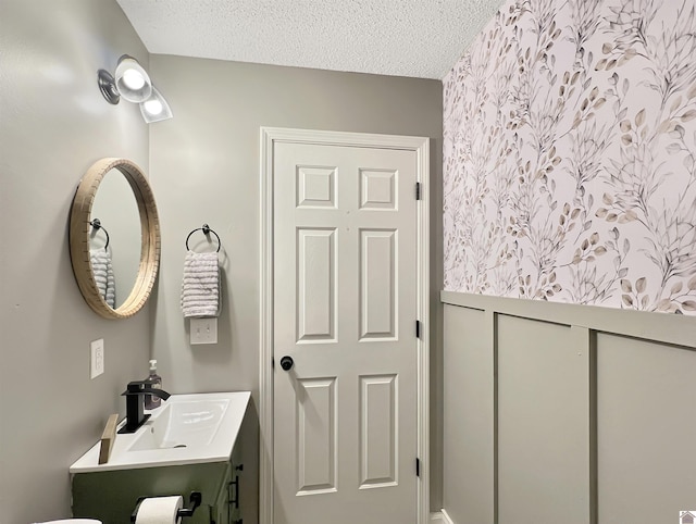 bathroom with a textured ceiling and vanity