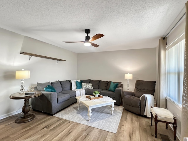 living room featuring a textured ceiling, light hardwood / wood-style floors, and plenty of natural light