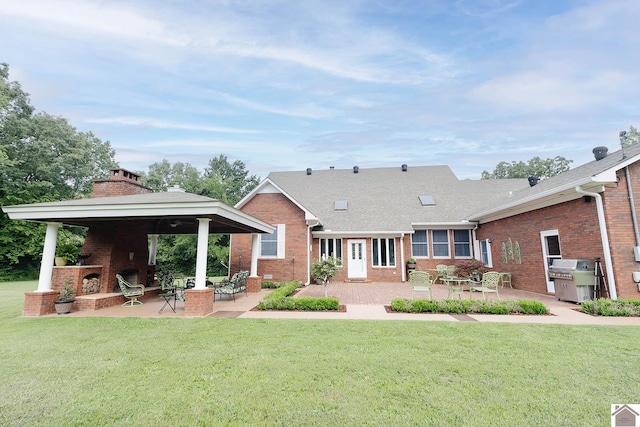 rear view of property with a patio area and a lawn