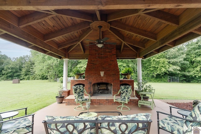 view of patio featuring a gazebo, an outdoor brick fireplace, and ceiling fan