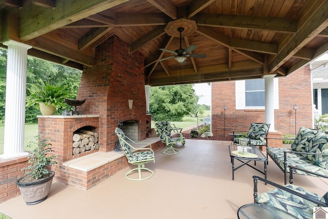 view of patio / terrace with ceiling fan, a gazebo, and an outdoor brick fireplace