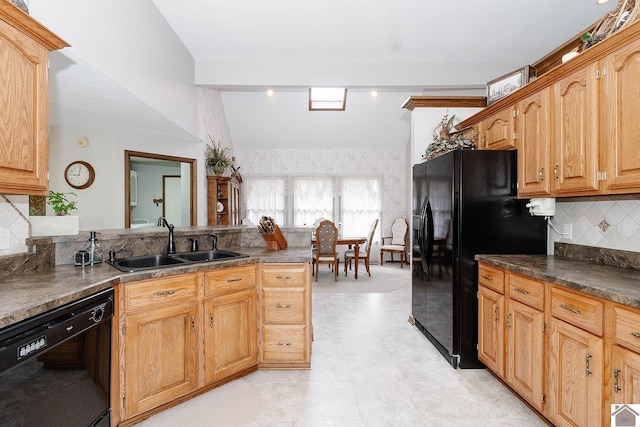 kitchen featuring black appliances, backsplash, lofted ceiling, and sink