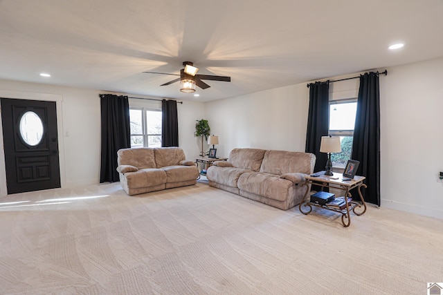 carpeted living room with ceiling fan