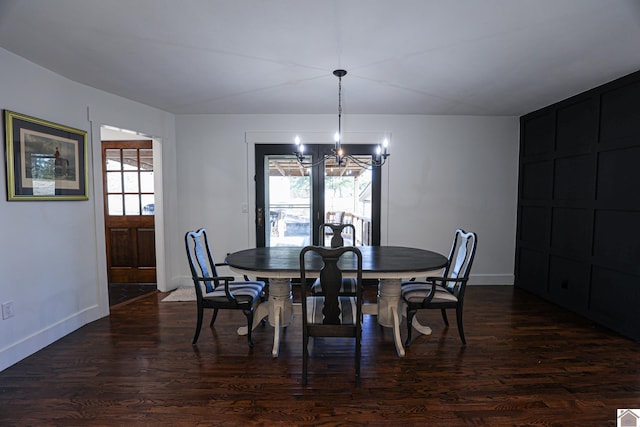 dining space featuring a chandelier and dark wood-type flooring