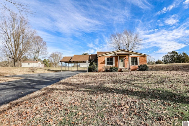 ranch-style home featuring a carport