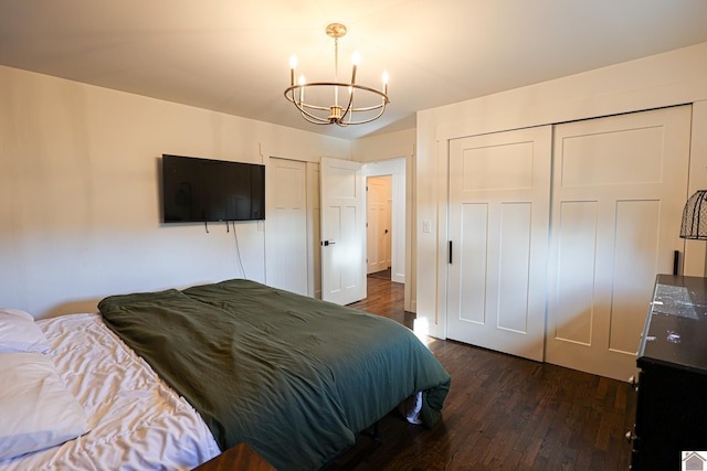 bedroom featuring a chandelier and dark hardwood / wood-style flooring