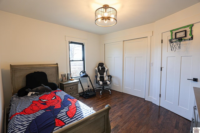 bedroom featuring a chandelier and dark hardwood / wood-style flooring