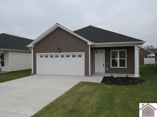 ranch-style home featuring a garage and a front lawn