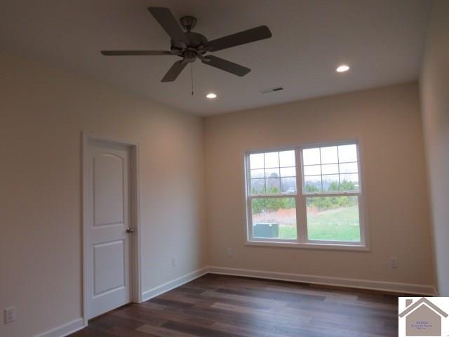 unfurnished room featuring ceiling fan and dark hardwood / wood-style flooring