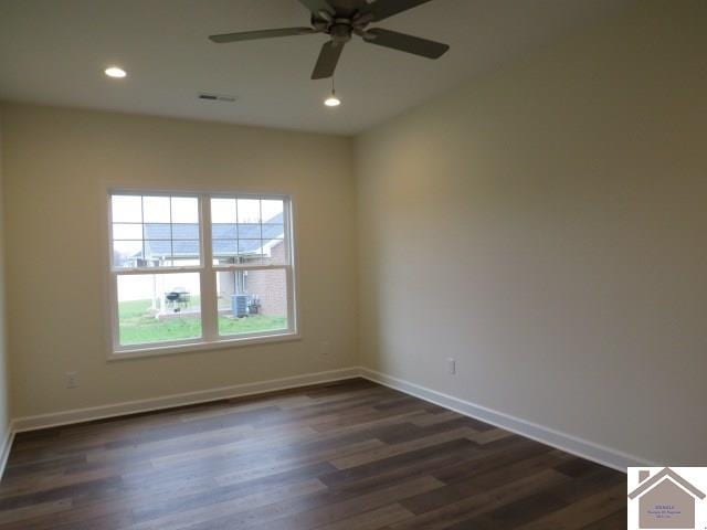 empty room with ceiling fan and dark hardwood / wood-style floors