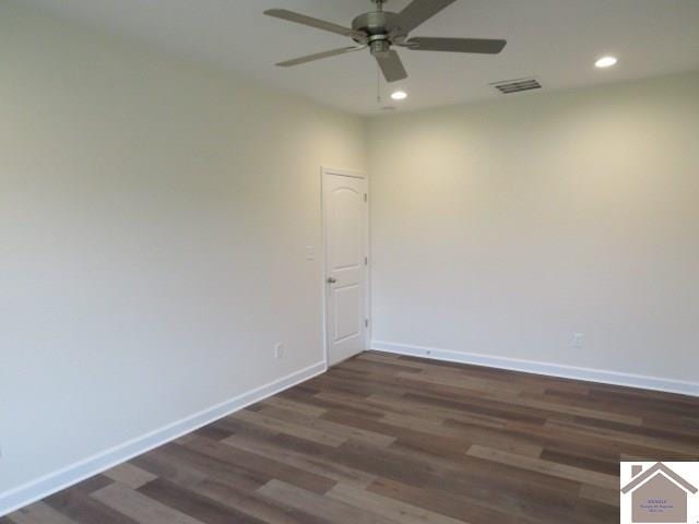 unfurnished room featuring dark wood-type flooring and ceiling fan