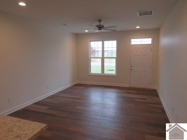 foyer with ceiling fan and dark wood-type flooring