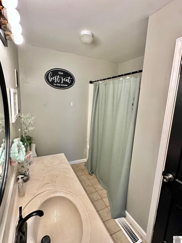 bathroom with a shower with curtain, vanity, and tile patterned flooring