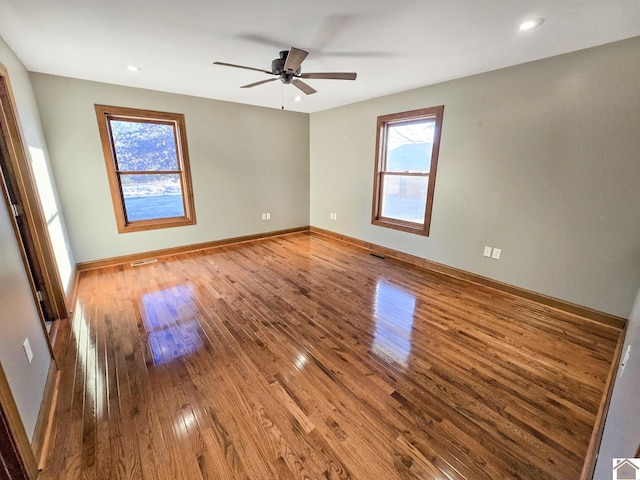 spare room featuring hardwood / wood-style flooring and ceiling fan