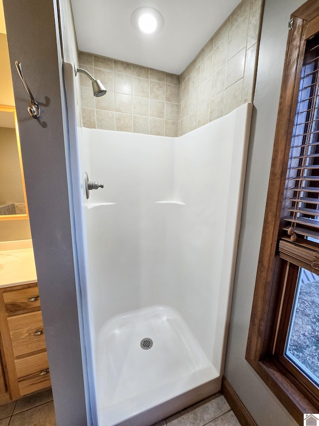 bathroom featuring tile patterned flooring and a shower