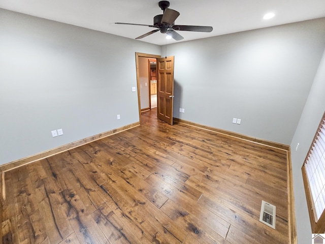 spare room with hardwood / wood-style floors and ceiling fan