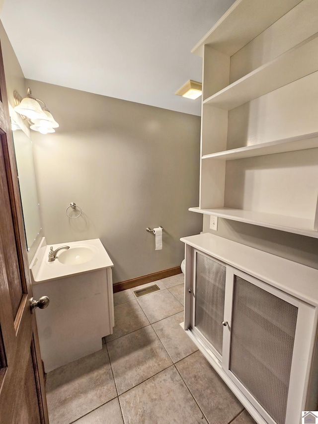 bathroom featuring vanity, toilet, and tile patterned flooring