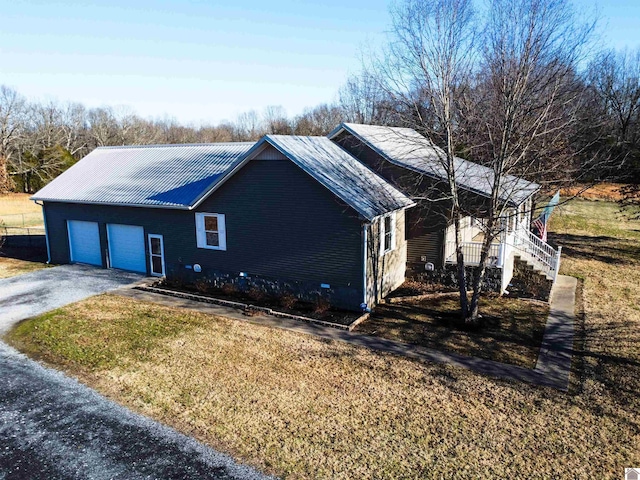 view of front of home with a garage and a front lawn