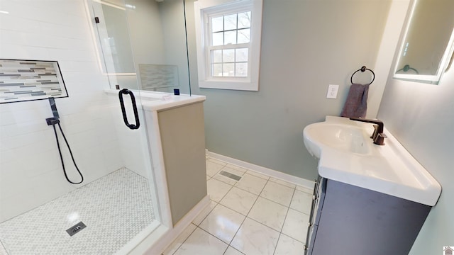 bathroom with vanity, tile patterned flooring, and a shower with door